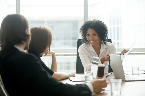 Woman talking to clients at meeting